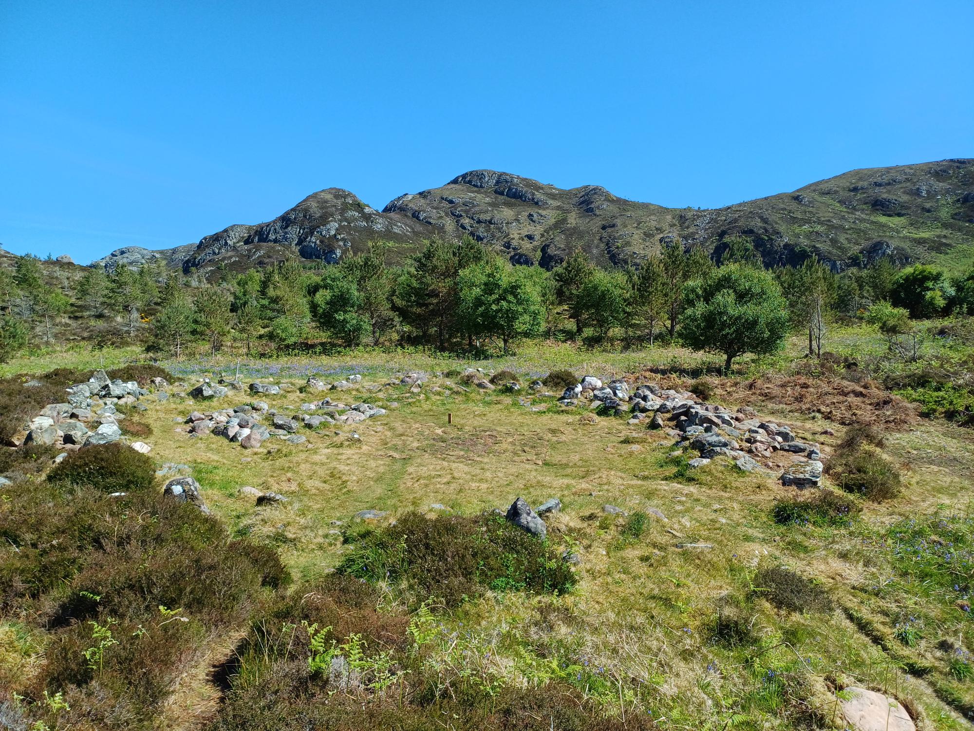 round house with mountains behind